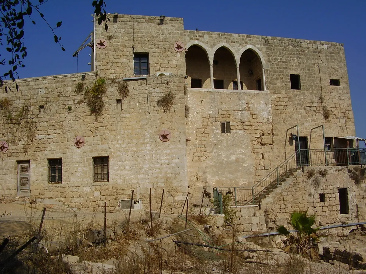 The stone Shuni fortress in Jabotinsky Park, with arched windows on its upper floor