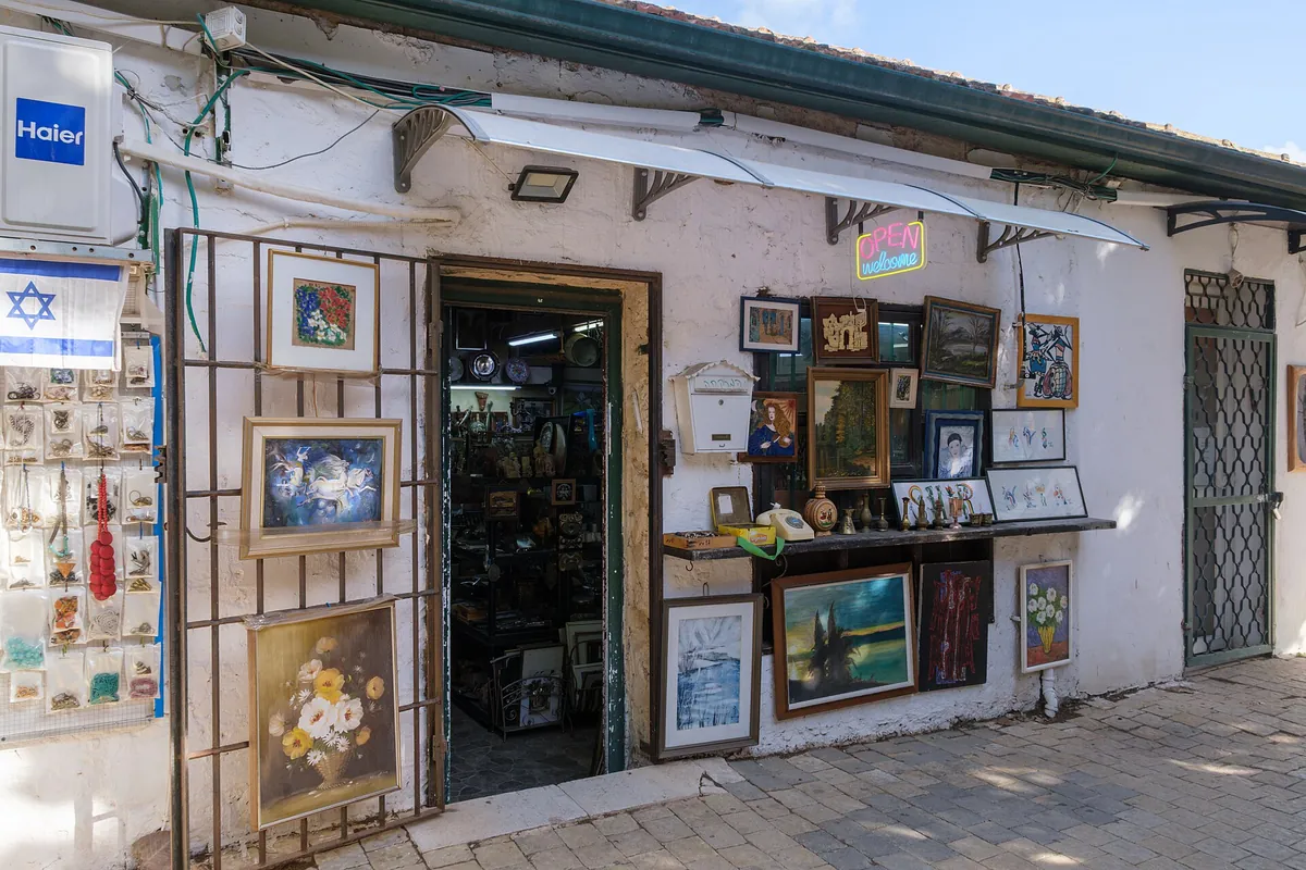 An art and antiques shop with paintings displayed outside, in the old moshava of Zichron Yaakov